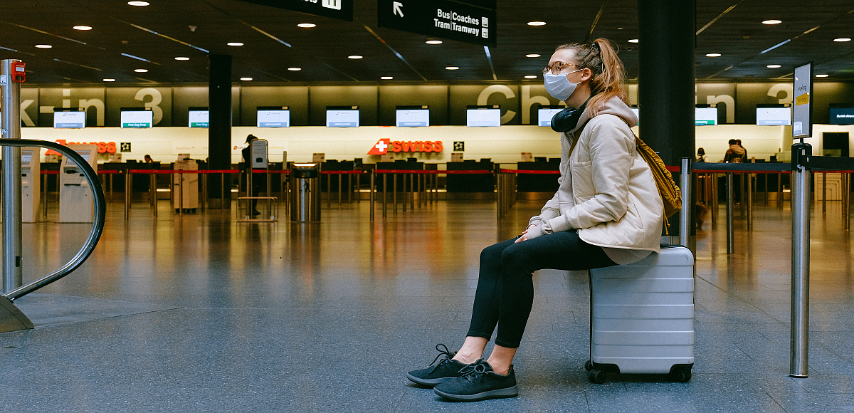 Girl in mask waiting to travel